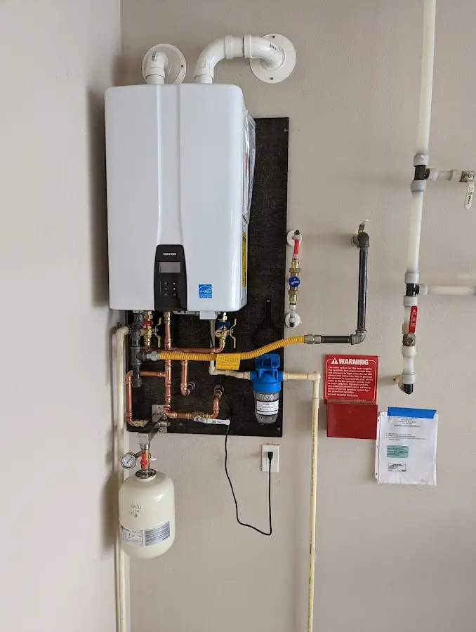 Professional plumber installing copper piping in a Weiser home